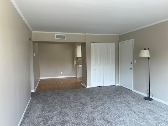 3901 Fort St Unit 202, Riverview, MI 48183 - unfurnished bedroom featuring carpet floors, crown molding, and a closet