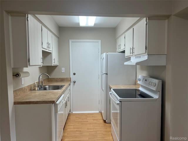 3901 Fort St Unit 202, Riverview, MI 48183 - kitchen featuring white appliances, under cabinet range hood, light wood-style flooring, white cabinets, and light countertops