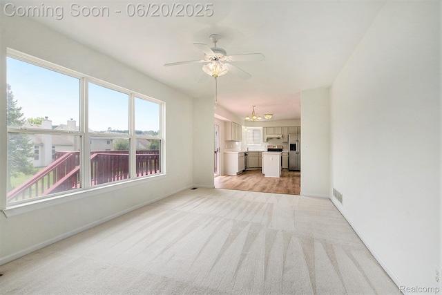 3244 Buckhorn Ct, Ann Arbor, MI 48105 - unfurnished living room with light colored carpet, ceiling fan, and a chandelier