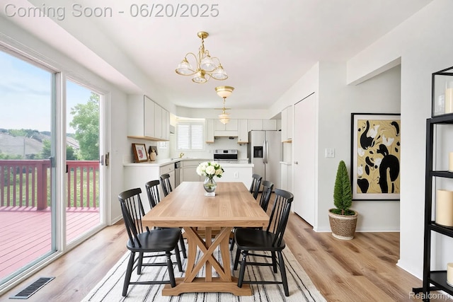 3244 Buckhorn Ct, Ann Arbor, MI 48105 - dining room with a chandelier and light wood-style floors