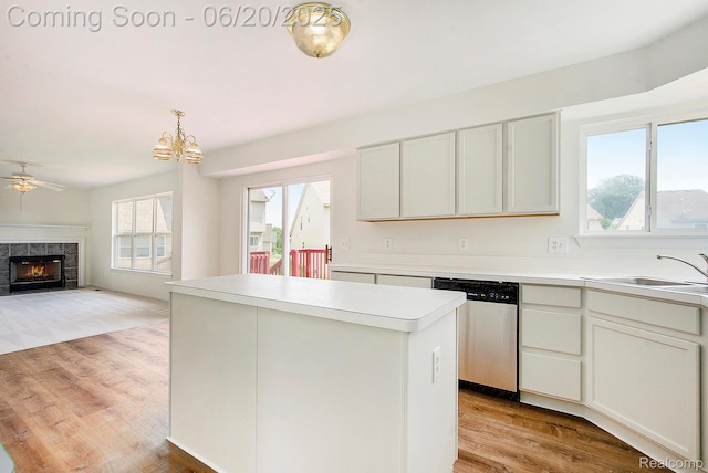 3244 Buckhorn Ct, Ann Arbor, MI 48105 - kitchen with stainless steel dishwasher, a kitchen island, light wood finished floors, and light countertops