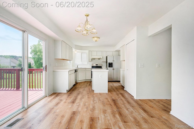 3244 Buckhorn Ct, Ann Arbor, MI 48105 - kitchen with appliances with stainless steel finishes, a chandelier, light countertops, light wood-style floors, and a center island