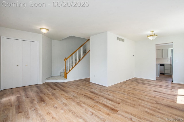 3244 Buckhorn Ct, Ann Arbor, MI 48105 - unfurnished living room with light wood-type flooring and stairway