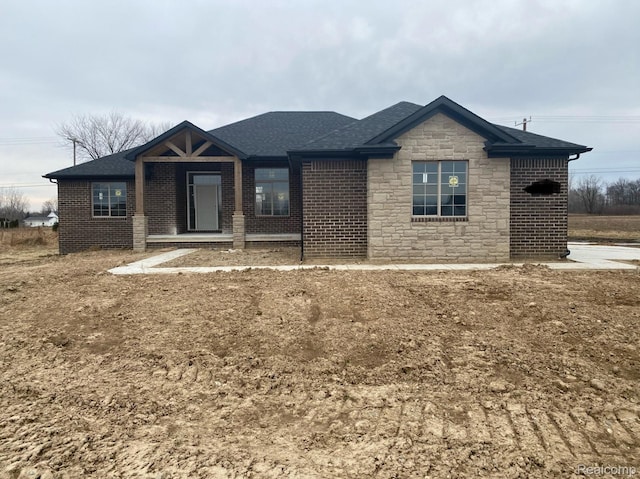 4940 Daisy Ln, Almont, MI 48003 - ranch-style house with roof with shingles, stone siding, and brick siding