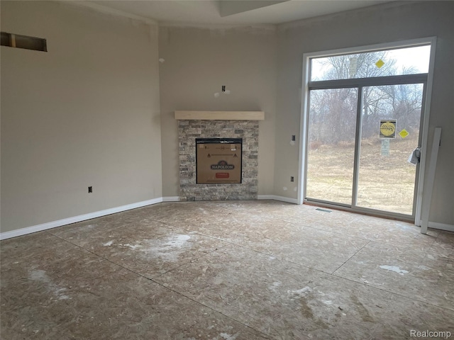 4940 Daisy Ln, Almont, MI 48003 - unfurnished living room featuring baseboards and a fireplace
