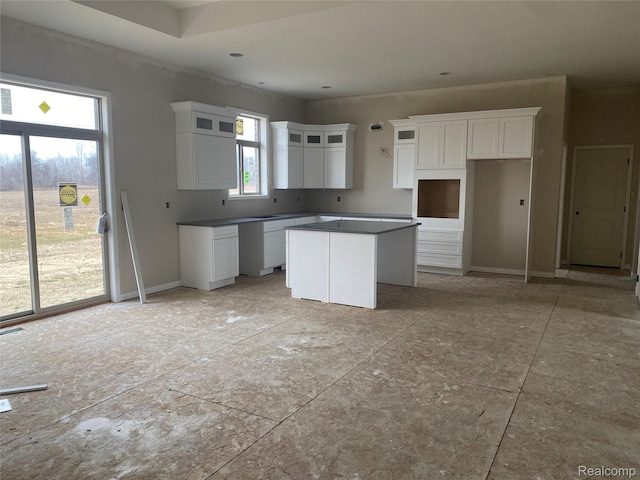 4940 Daisy Ln, Almont, MI 48003 - kitchen with a center island, white cabinetry, and glass insert cabinets
