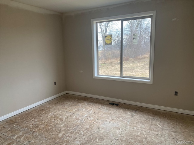 4940 Daisy Ln, Almont, MI 48003 - spare room featuring baseboards