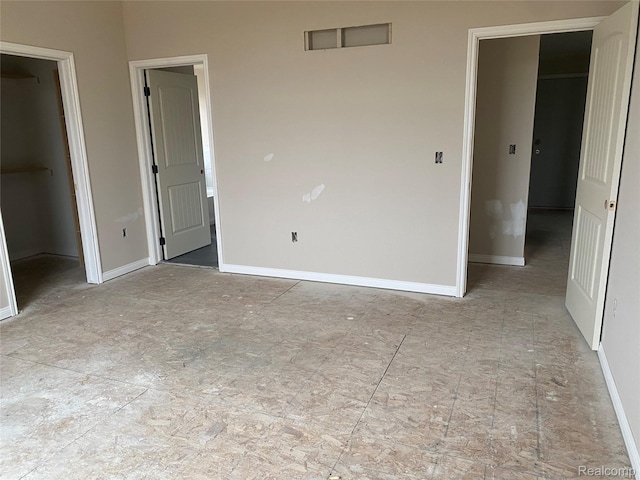 4940 Daisy Ln, Almont, MI 48003 - unfurnished bedroom featuring a walk in closet and a closet