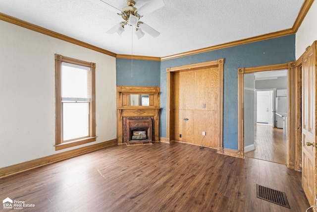 320 E Main St, Flushing, MI 48433 - unfurnished living room with a ceiling fan, wood finished floors, ornamental molding, a fireplace, and a textured ceiling