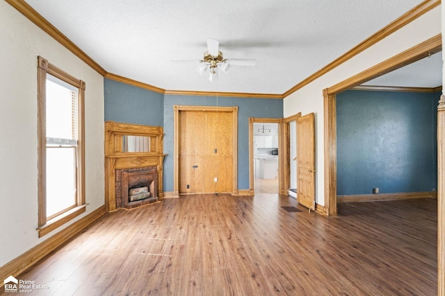 320 E Main St, Flushing, MI 48433 - unfurnished living room with a fireplace, wood finished floors, ceiling fan, ornamental molding, and plenty of natural light