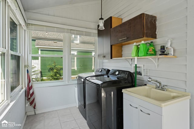 320 E Main St, Flushing, MI 48433 - laundry area with washer and clothes dryer, cabinet space, and light tile patterned floors