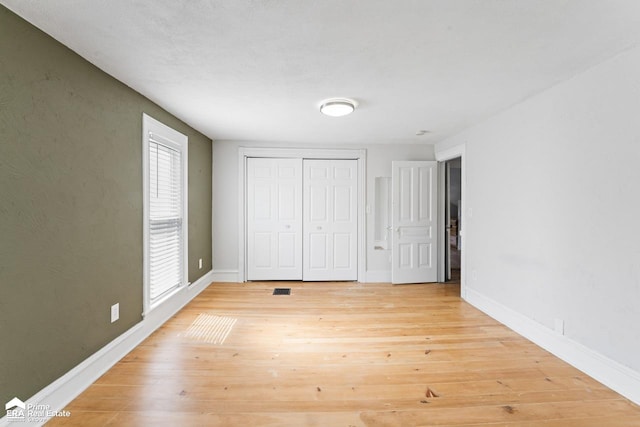 320 E Main St, Flushing, MI 48433 - unfurnished bedroom with light wood-type flooring and a closet