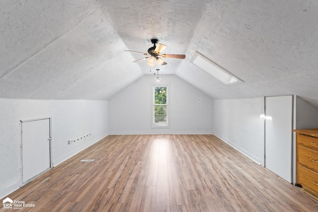320 E Main St, Flushing, MI 48433 - bonus room featuring light wood-type flooring, a ceiling fan, a skylight, lofted ceiling, and a textured ceiling
