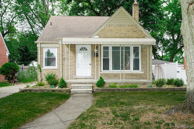 1922 N Wilson Ave, Royal Oak, MI 48073 - view of front of home with a shingled roof, a chimney, and brick siding