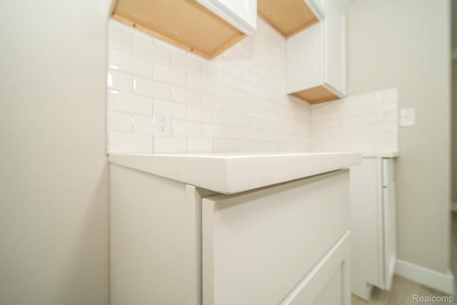 1922 N Wilson Ave, Royal Oak, MI 48073 - detailed view of decorative backsplash, white cabinets, and light countertops