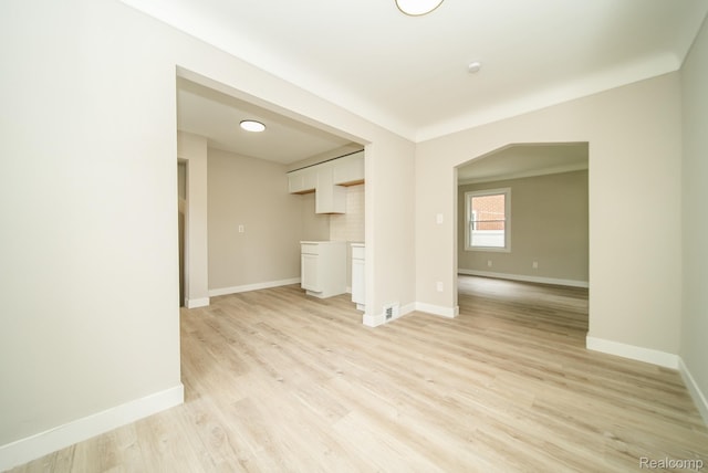 1922 N Wilson Ave, Royal Oak, MI 48073 - unfurnished living room with baseboards and light wood-type flooring