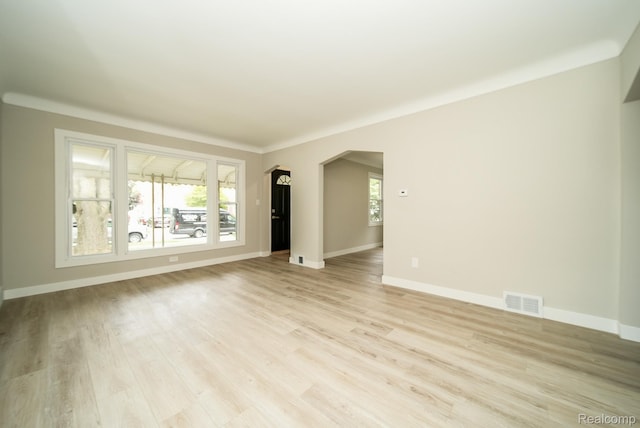 1922 N Wilson Ave, Royal Oak, MI 48073 - unfurnished living room featuring arched walkways and light wood-style flooring