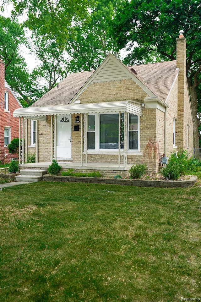 1922 N Wilson Ave, Royal Oak, MI 48073 - view of front of house with brick siding, a front yard, and a shingled roof