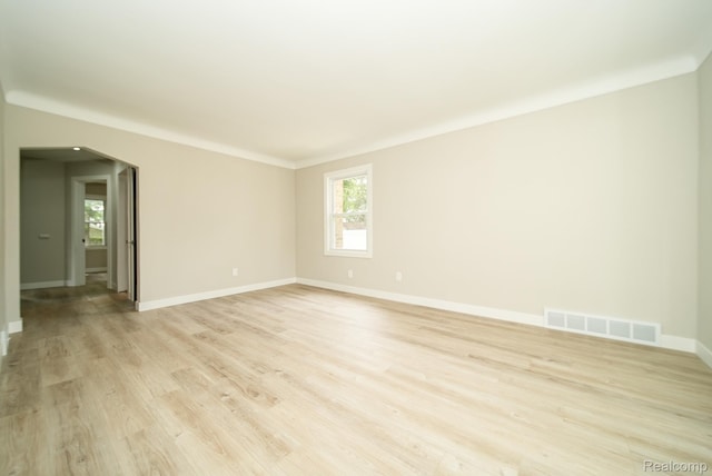1922 N Wilson Ave, Royal Oak, MI 48073 - empty room featuring light wood finished floors, plenty of natural light, and arched walkways