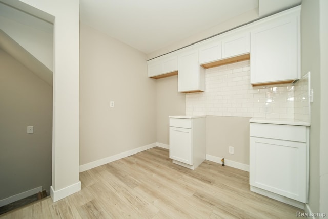 1922 N Wilson Ave, Royal Oak, MI 48073 - kitchen featuring decorative backsplash, light wood-style flooring, white cabinets, and light countertops
