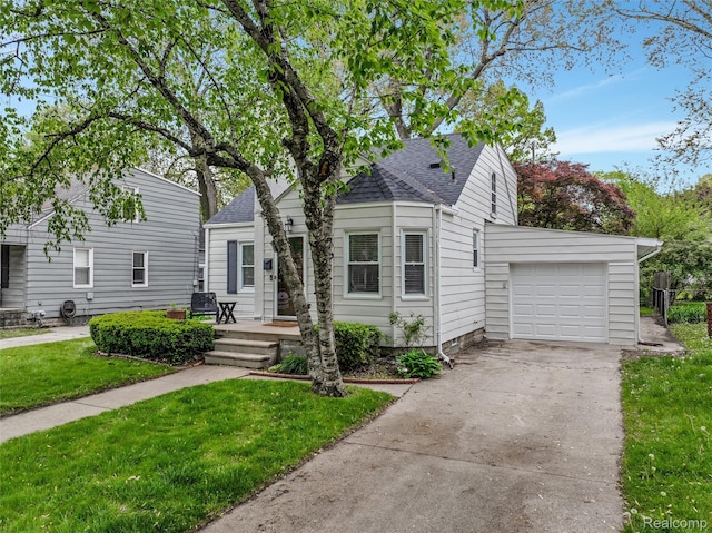 1605 N Vermont Ave, Rochester, MI 48067 - bungalow-style house with a garage, roof with shingles, a front yard, and concrete driveway