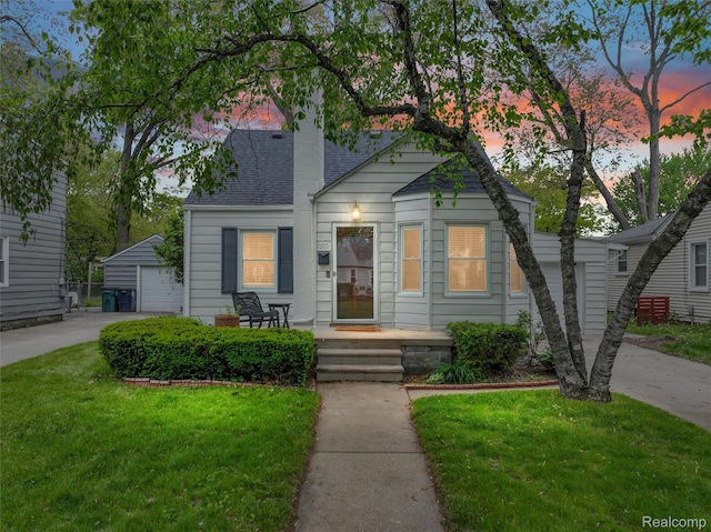 1605 N Vermont Ave, Rochester, MI 48067 - view of front facade featuring an outbuilding, a yard, a detached garage, a porch, and a chimney