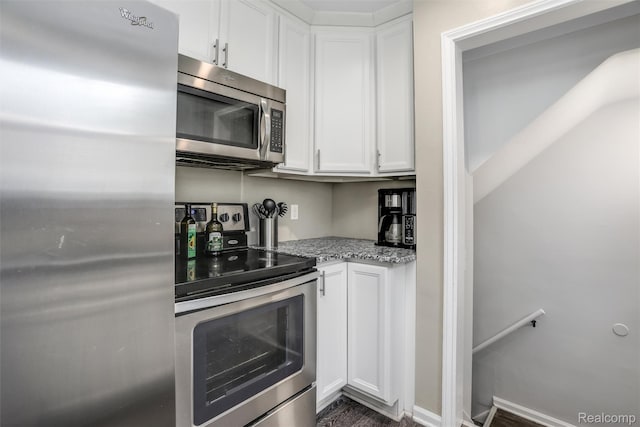 1605 N Vermont Ave, Rochester, MI 48067 - kitchen with stainless steel appliances, light stone counters, white cabinets, and dark wood finished floors