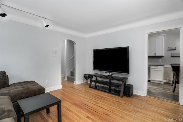 1605 N Vermont Ave, Rochester, MI 48067 - living room with arched walkways, stairs, light wood-type flooring, and rail lighting