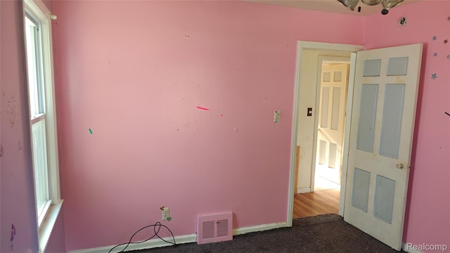 5157 Niagara St, Wayne, MI 48184 - empty room featuring dark colored carpet and baseboards