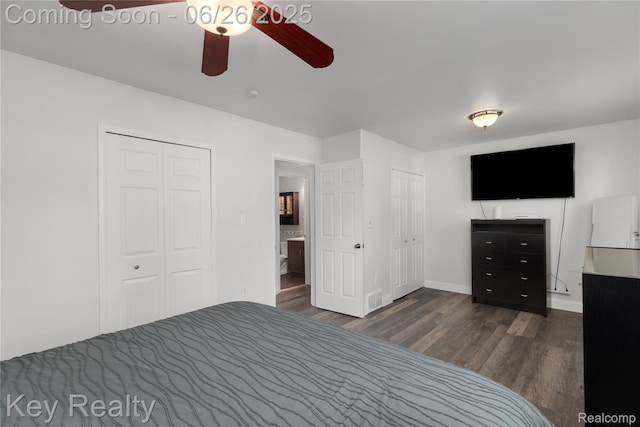 9468 Washington St, Romulus, MI 48174 - unfurnished bedroom with dark wood-type flooring, two closets, and ceiling fan