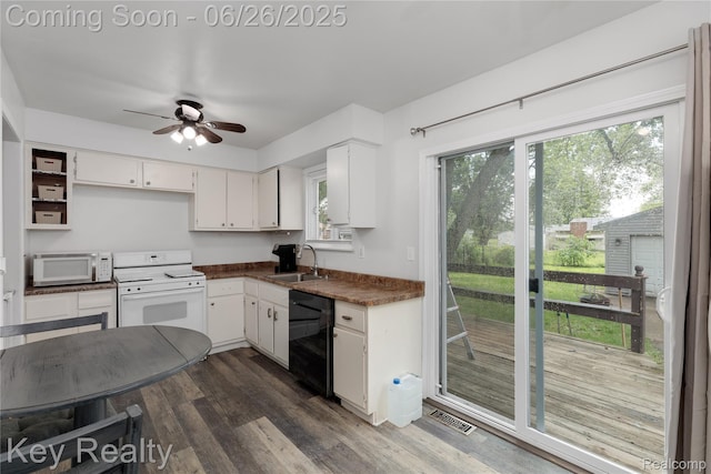 9468 Washington St, Romulus, MI 48174 - kitchen featuring white appliances, dark countertops, a ceiling fan, white cabinets, and dark wood finished floors