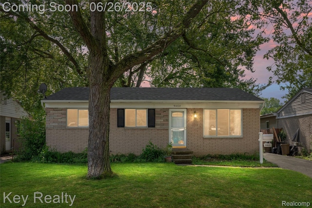 9468 Washington St, Romulus, MI 48174 - view of front facade featuring brick siding, entry steps, and a yard