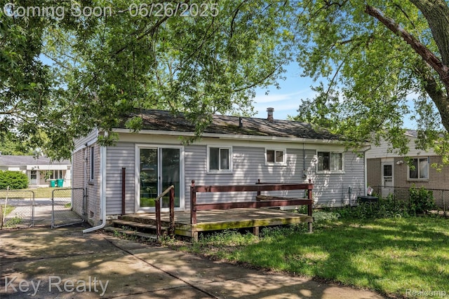 9468 Washington St, Romulus, MI 48174 - rear view of house with a wooden deck and a gate