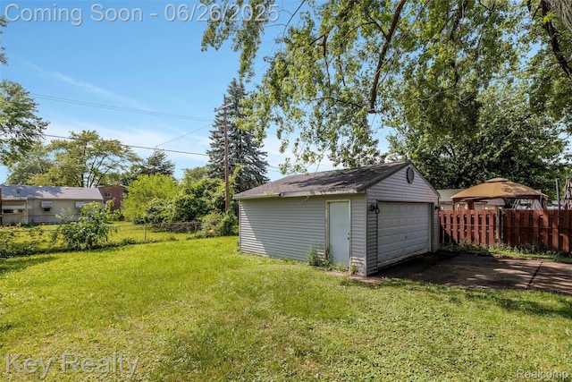 9468 Washington St, Romulus, MI 48174 - view of yard with a detached garage and an outdoor structure