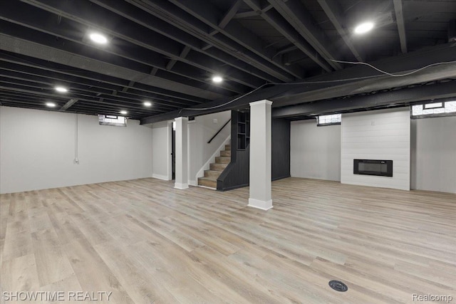 24611 Kenosha St, Oak Park, MI 48237 - basement featuring stairway, wood finished floors, and a large fireplace