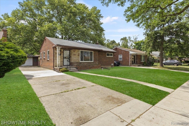 24611 Kenosha St, Oak Park, MI 48237 - view of front of home featuring a front yard, brick siding, and an outdoor structure