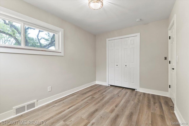 24611 Kenosha St, Oak Park, MI 48237 - unfurnished bedroom featuring wood finished floors and a closet