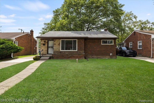 24611 Kenosha St, Oak Park, MI 48237 - bungalow with a front yard, brick siding, and roof with shingles