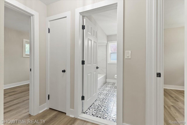 24611 Kenosha St, Oak Park, MI 48237 - full bathroom featuring plenty of natural light, a tub to relax in, and wood finished floors