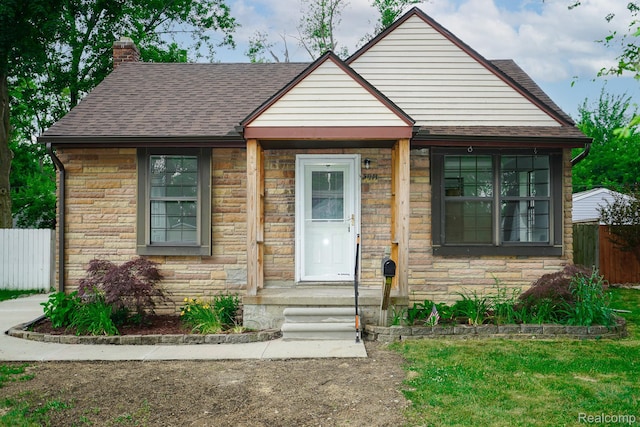 3911 Thomas Ave, Berkley, MI 48072 - view of front facade featuring stone siding, a chimney, and roof with shingles