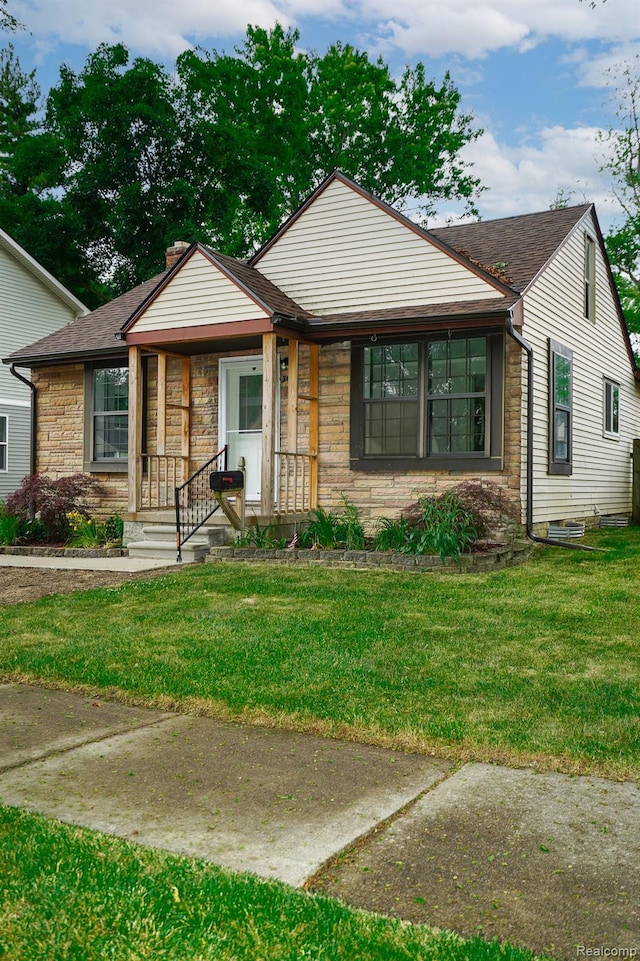 3911 Thomas Ave, Berkley, MI 48072 - view of front of home with stone siding, a front yard, and roof with shingles