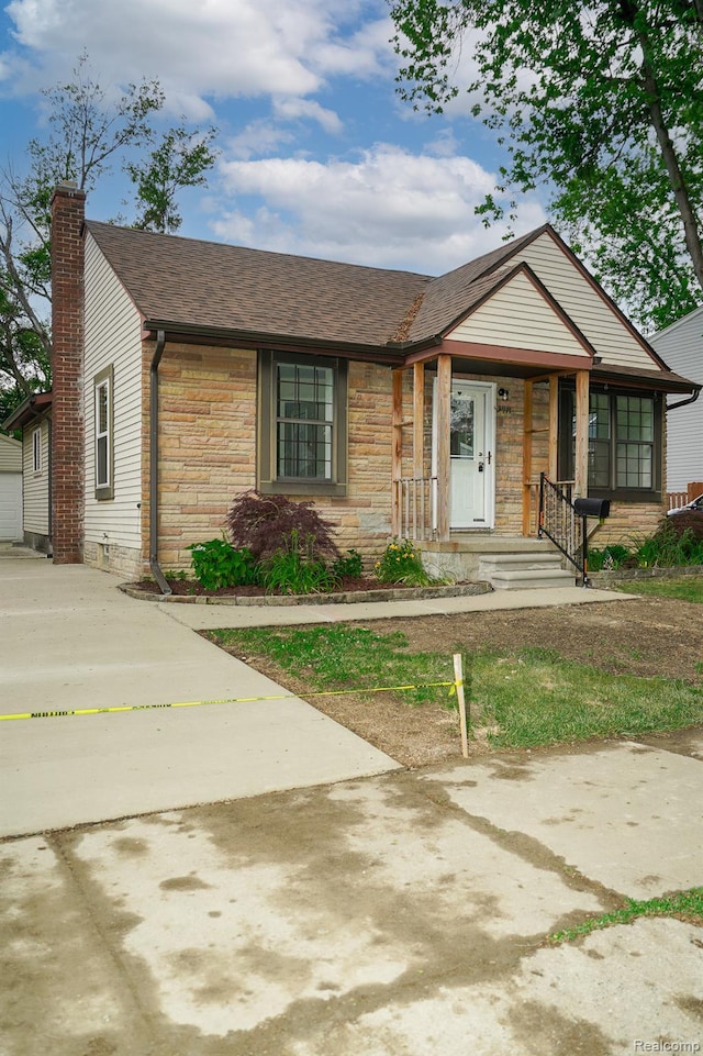 3911 Thomas Ave, Berkley, MI 48072 - view of front of home featuring a chimney, stone siding, a shingled roof, and a garage