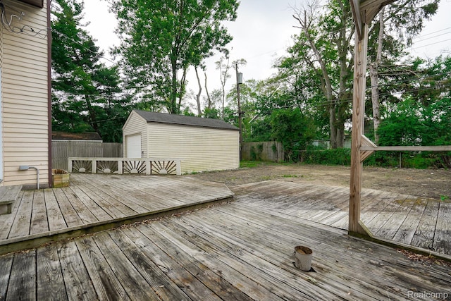 3911 Thomas Ave, Berkley, MI 48072 - wooden deck featuring a fenced backyard, a storage unit, and a garage
