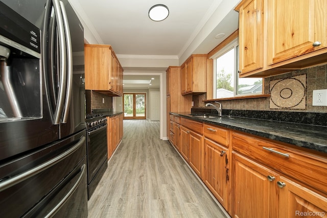 3911 Thomas Ave, Berkley, MI 48072 - kitchen with stainless steel fridge with ice dispenser, black gas range, light wood finished floors, backsplash, and dark stone countertops
