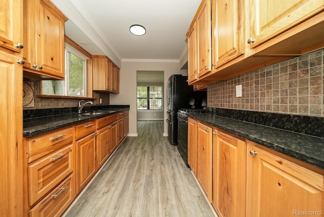 3911 Thomas Ave, Berkley, MI 48072 - kitchen featuring light wood-type flooring, ornamental molding, gas stove, decorative backsplash, and dark stone counters