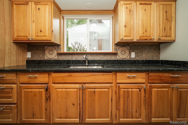 3911 Thomas Ave, Berkley, MI 48072 - kitchen with backsplash, dark stone counters, and brown cabinetry