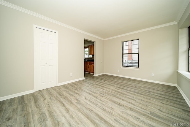 3911 Thomas Ave, Berkley, MI 48072 - unfurnished bedroom with crown molding, wood finished floors, multiple windows, ensuite bath, and a closet