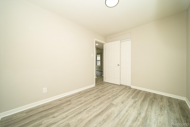 3911 Thomas Ave, Berkley, MI 48072 - unfurnished bedroom with wood finished floors and a closet