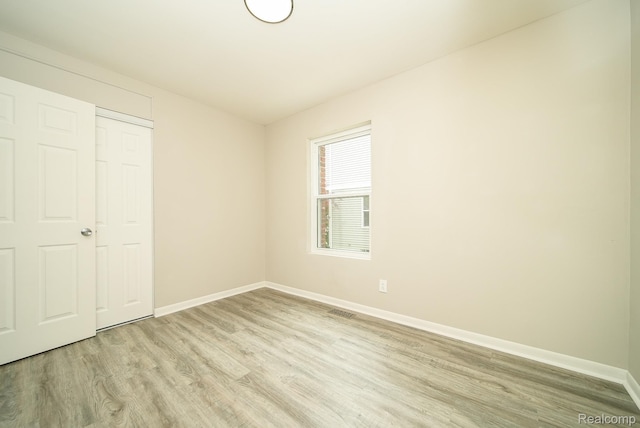 3911 Thomas Ave, Berkley, MI 48072 - unfurnished bedroom with light wood finished floors and baseboards