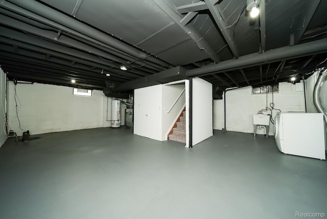 3911 Thomas Ave, Berkley, MI 48072 - basement featuring gas water heater, stairway, and washer / dryer